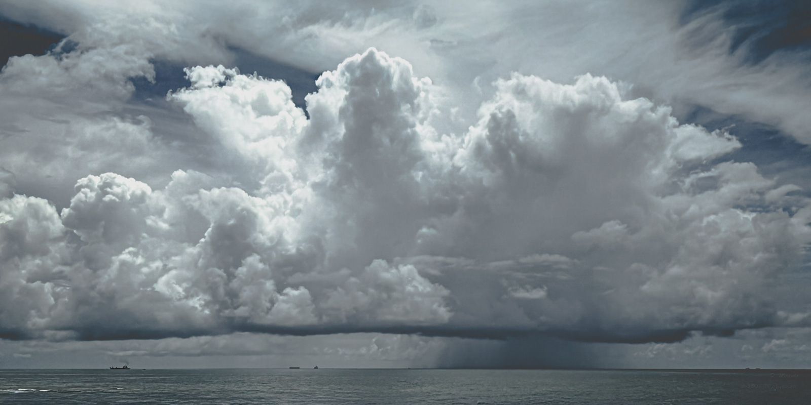 Slide 3: Rain shaft over a maritime horizon
