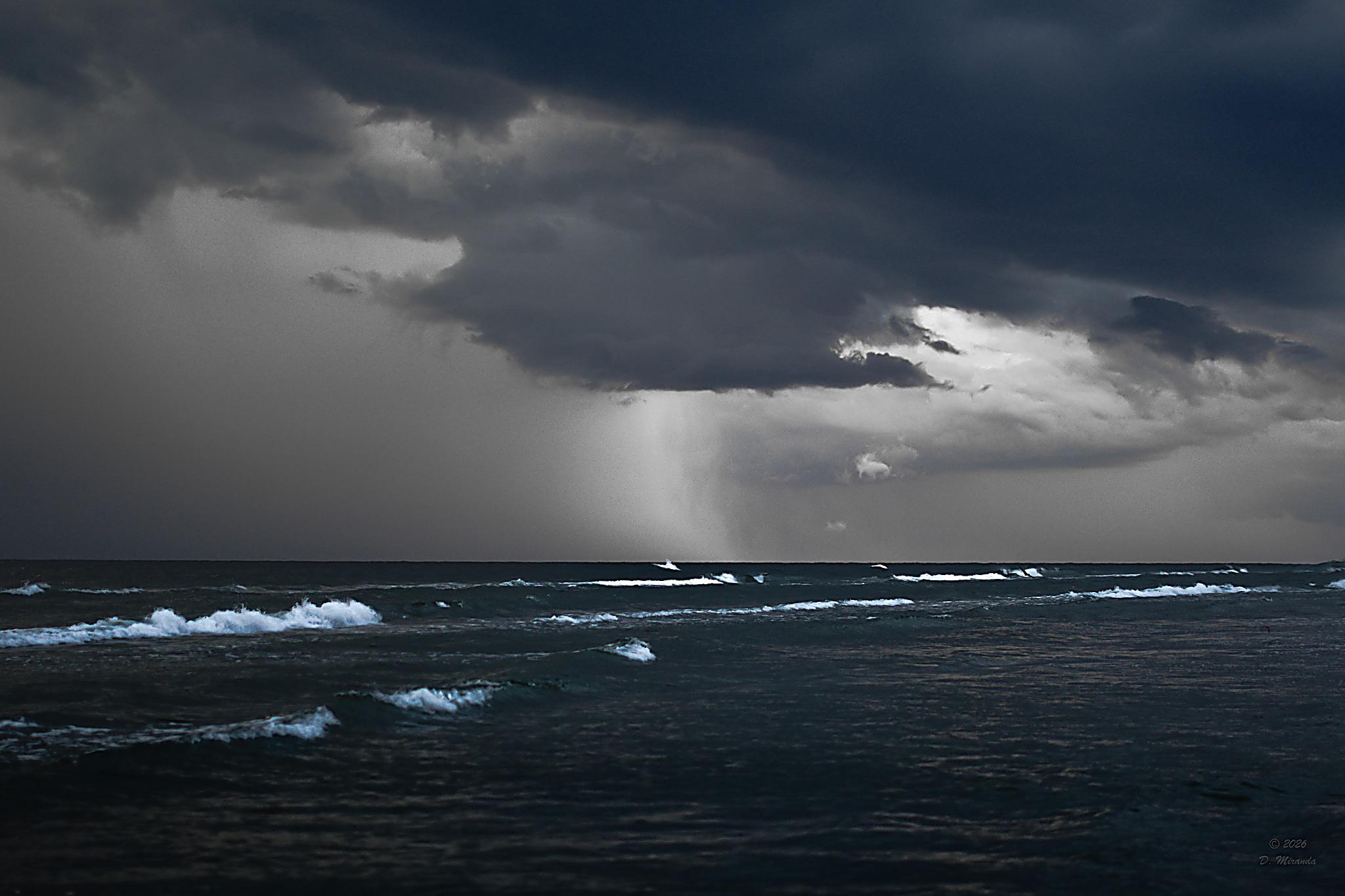 Storm clouds over a quiet coastal horizon